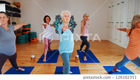 Senior, people and stretching arms in yoga class for fitness, exercise and spiritual balance for wellness. Elderly women, warm up and warrior pose of pilates lesson, holistic healing and health club 126102351