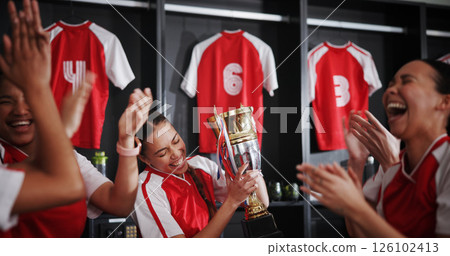 Happy women, soccer team and celebration with trophy for winning, victory or tournament in locker room. Excited, female people or sports players with smile for competition, success or award together Happy women, soccer team and celebration with trophy for winning, victory or tournament in locker room. Excited, female people or sports players with smile for competition, success or award together 126102413