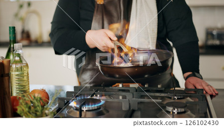 Cooking, flame and man in kitchen, hands and frying pan with food, wellness and ingredients. Closeup, person and chef with utensils, fire or meal prep with nutrition, culinary skills or flambe expert Cooking, flame and man in kitchen, hands and frying pan with food, wellness and ingredients. Closeup, person and chef with utensils, fire or meal prep with nutrition, culinary skills or flambe expert 126102430