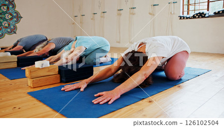 Group, elderly and people stretching in yoga class for fitness, exercise and spiritual wellness. Senior women, warm up and childs pose of pilates lesson, community and holistic balance at health club Group, elderly and people stretching in yoga class for fitness, exercise and spiritual wellness. Senior women, warm up and childs pose of pilates lesson, community and holistic balance at health club 126102504