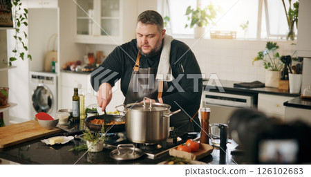 Class, cooking and man with live streaming in kitchen for online tutorial, dinner meal and recipe recording. Culinary influencer, content creation and person with cuisine preparation and vlog in home Class, cooking and man with live streaming in kitchen for online tutorial, dinner meal and recipe recording. Culinary influencer, content creation and person with cuisine preparation and vlog in home 126102683