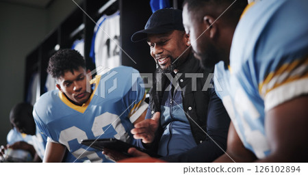 Tablet, coaching and football team with men in locker room for game plan, sports strategy or defense formation. Touchdown tactics, match feedback and discussion with people and advice for training Tablet, coaching and football team with men in locker room for game plan, sports strategy or defense formation. Touchdown tactics, match feedback and discussion with people and advice for training 126102894