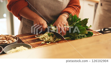 Hands, spinach and cutting board in kitchen, home and meal prep with knife, vegetables or cooking healthy food. Person, chef and tools for organic produce, nutrition or diet for wellness at apartment Hands, spinach and cutting board in kitchen, home and meal prep with knife, vegetables or cooking healthy food. Person, chef and tools for organic produce, nutrition or diet for wellness at apartment 126102904
