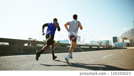 Men, back and running with road in city for workout, exercise or outdoor cardio training. Active, male people or runners with fitness on street for sport, marathon or sprint together in an urban town 126103023