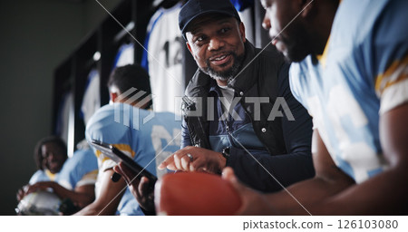 Black men, coach and football captain on tablet in locker room for game plan, strategy and layout. African mentor, athlete and sports trainer on technology for brainstorming match and play routine Black men, coach and football captain on tablet in locker room for game plan, strategy and layout. African mentor, athlete and sports trainer on technology for brainstorming match and play routine 126103080