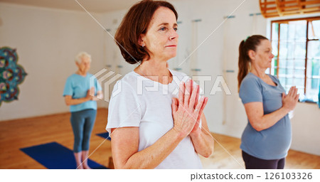 Breathing, namaste and women in group meditation for calm mindset, zen or peace in mental wellness. Posture, morning and mature people in class together for mindfulness, relax or holistic self care. Breathing, namaste and women in group meditation for calm mindset, zen or peace in mental wellness. Posture, morning and mature people in class together for mindfulness, relax or holistic self care. 126103326