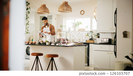 Man, tablet and preparation with kitchen, recipe and home with food ingredients and internet instructions. Technology, blog and cooking with chef person in apartment for diet, health or nutrition Man, tablet and preparation with kitchen, recipe and home with food ingredients and internet instructions. Technology, blog and cooking with chef person in apartment for diet, health or nutrition 126103707