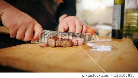 Kitchen, hands or man with steak, cutting or culinary skills with food, knife or healthy ingredients. Person, closeup or chef with wood board, home or beef cuisine with recipe, nutrition or meal prep 126103935