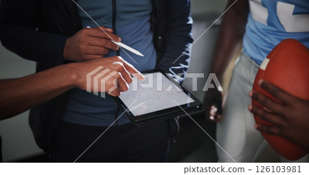 Tablet screen, coaching and football with hands in locker room for game plan, sports strategy or defense formation. Touchdown tactics, match feedback and discussion with people and training advice 126103981