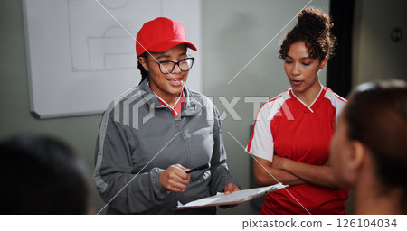 Women, coach and meeting with soccer players for game plan, strategy or discussion together. Female people, trainer or coordinator talking to group or team with clipboard for sport match or formation 126104034