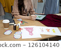 designer is using electronic  pencil for Clothing design 126104140