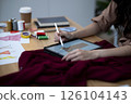 designer is using electronic Clothing design pencil on a tablet 126104143