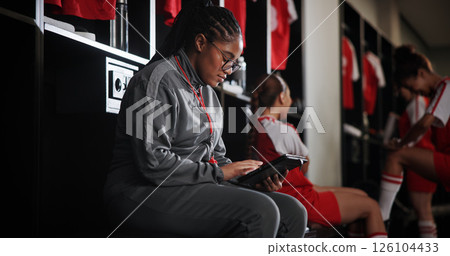 Woman, soccer coach and schedule with tablet for game time, matchup or attendance list in locker room. Female person, manager or coordinator with technology or app for fixtures or player registration Woman, soccer coach and schedule with tablet for game time, matchup or attendance list in locker room. Female person, manager or coordinator with technology or app for fixtures or player registration 126104433
