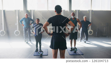 Personal trainer, senior people and workout at gym with stretching, guide and teaching for fitness. Coach, group and warm up at class for training, learning or exercise at wellness club in retirement 126104713