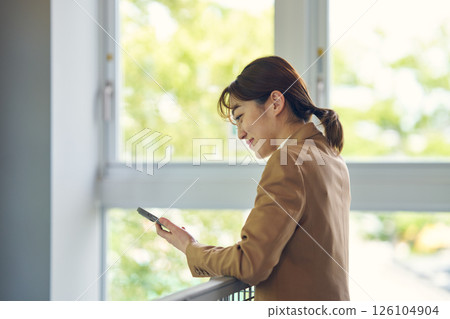 A woman watching a smartphone 126104904