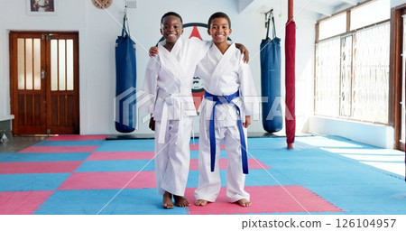 Hug, karate and portrait of children in dojo for martial arts, self defense or sports training. Development, fitness and smile of student friends embracing in class together for exercise or workout Hug, karate and portrait of children in dojo for martial arts, self defense or sports training. Development, fitness and smile of student friends embracing in class together for exercise or workout 126104957