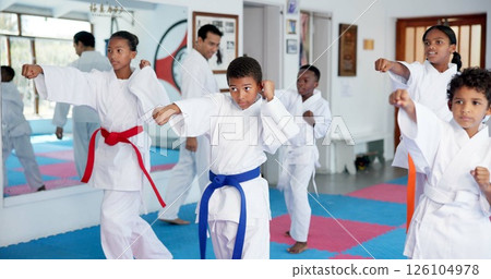 Fitness, karate and sports with kids in class for combat, fighting or self defense training. Development, exercise or growth with children and sensei in dojo for martial arts lesson or practice 126104978