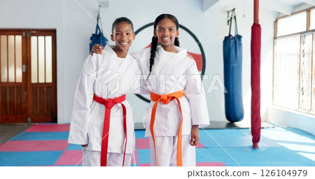 Hug, karate and portrait of students in dojo for martial arts, self defense or sports training. Development, fitness and smile of child friends embracing in class together for exercise or workout 126104979