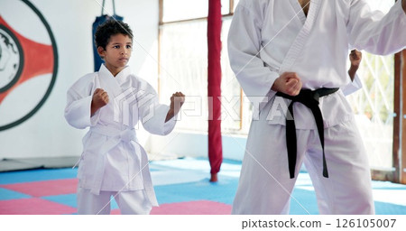 Boy, lesson and sensei with student in karate class, self defense pose or martial arts with youth for combat education. Taekwondo training, stance and instructor with male child for coaching in dojo 126105007