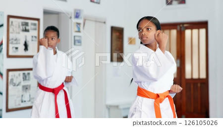 Girl, children or karate student in dojo for combat, fighting tournament or sports training with dedication. Exercise, fitness workout or kids in gym for martial arts education, development or growth Girl, children or karate student in dojo for combat, fighting tournament or sports training with dedication. Exercise, fitness workout or kids in gym for martial arts education, development or growth 126105026