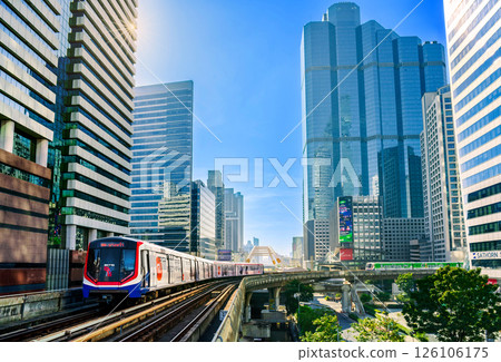 BTS Skytrain travels through central Bangkok surrounded by modern skyscrapers on a clear sunny morning BTS Skytrain travels through central Bangkok surrounded by modern skyscrapers on a clear sunny morning 126106175