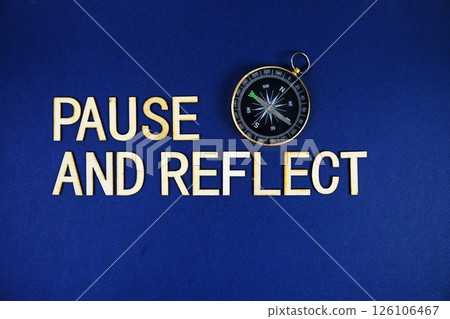 Pause And Relect alphabet letters with compass on navy blue background Pause And Relect alphabet letters with compass on navy blue background 126106467