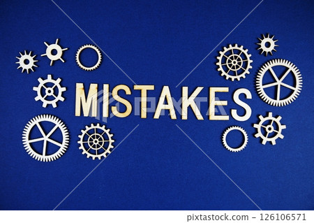 Mistake alphabet letters with gears element on navy blue background Mistake alphabet letters with gears element on navy blue background 126106571