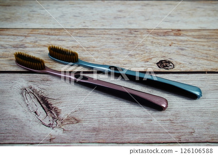 Toothbrushes flat lay on wooden background 126106588