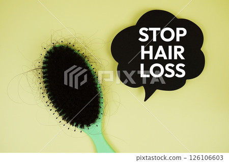 Stop Hair Loss text with magnifying glass and Severe hair loss with comb brush on pink background Stop Hair Loss text with magnifying glass and Severe hair loss with comb brush on pink background 126106603