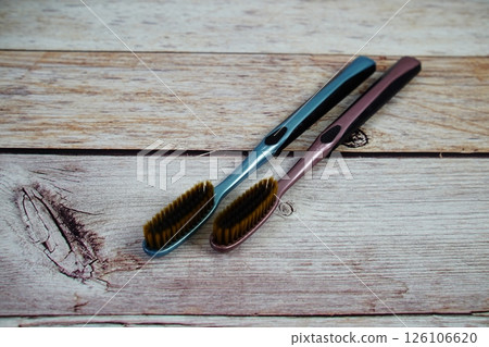 Toothbrushes flat lay on wooden background 126106620