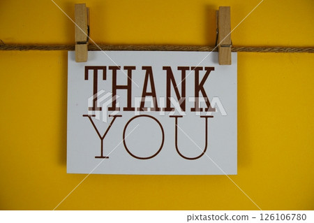 Thank You text on paper card on yellow background Thank You text on paper card on yellow background 126106780