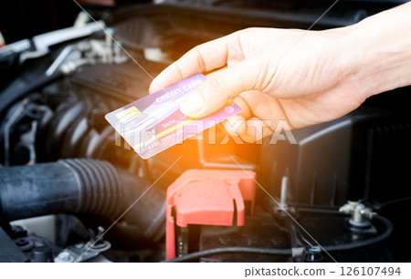 Young man's hand Blue credit card machine holding automobile background 126107494