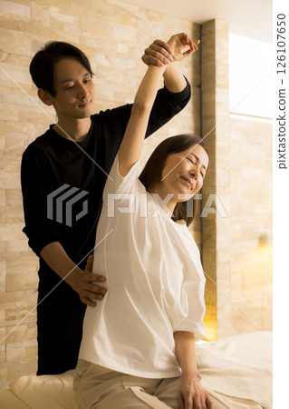 Senior woman receiving massage 126107650