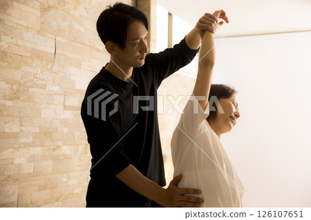 Senior woman receiving massage Senior woman receiving massage 126107651