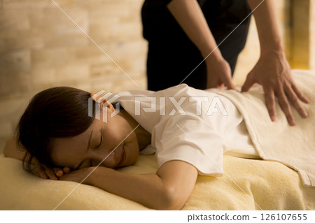 Senior woman receiving massage Senior woman receiving massage 126107655