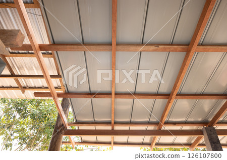 Roof under construction with metal sheet and wood structure. 126107800