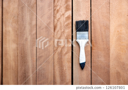 Paint brush and wood material in construction work. Paint brush and wood material in construction work. 126107801