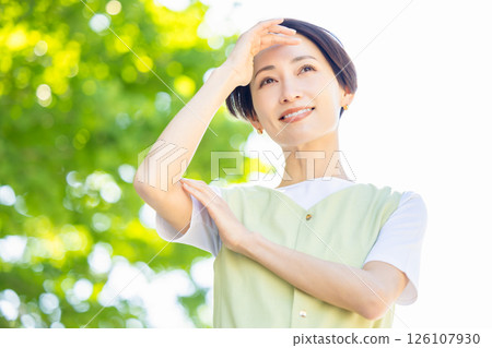 Beauty: A woman blocking the sun with her hand Beauty: A woman blocking the sun with her hand 126107930