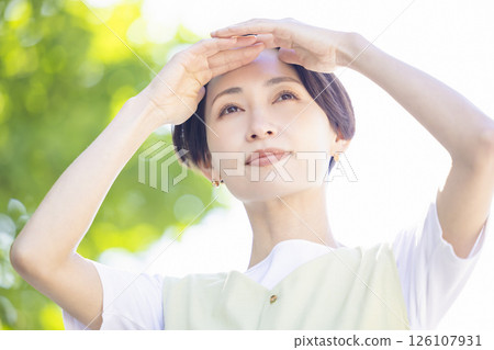 Beauty: A woman blocking the sun with her hand 126107931