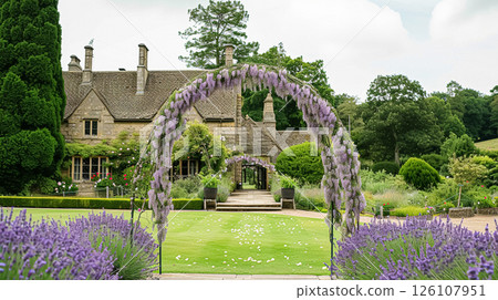 A floral archway adorned with purple lavender flowers, set up for a wedding ceremony in a garden 126107951