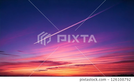 3DCG illustration of an airplane flying through a red sunset sky while creating a contrail 126108792