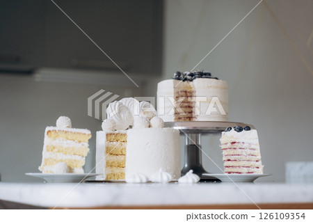 Assorted Layered Cakes Displayed on Marble Counter Assorted Layered Cakes Displayed on Marble Counter 126109354