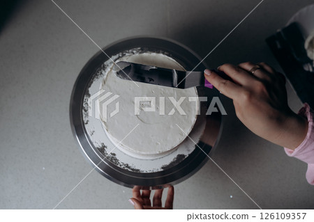 Cake Frosting in Progress by Skilled Baker 126109357