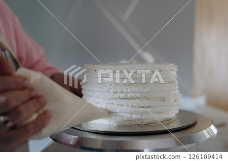 Cake Frosting Decoration with Piping Bag Technique 126109414