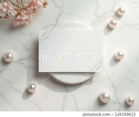Elegant flat lay of blank card and decorative pearls with cherry blossoms on a marble surface Elegant flat lay of blank card and decorative pearls with cherry blossoms on a marble surface 126109612