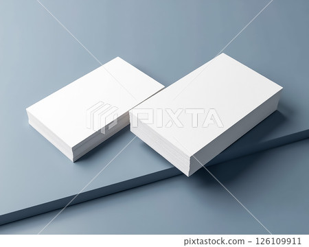 Blank business cards stacked on a blue table, ready for printing and customization in an office setting Blank business cards stacked on a blue table, ready for printing and customization in an office setting 126109911