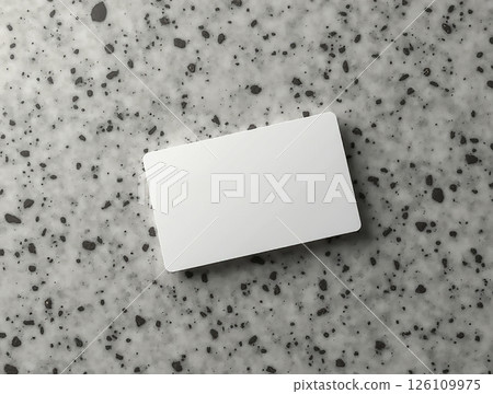 Simple white card placed on a textured gray surface in a modern setting during daylight 126109975