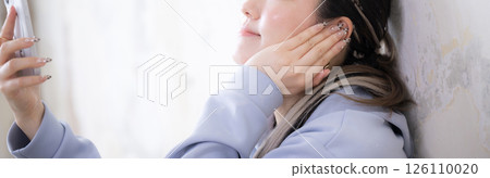 A faceless banner depicting someone listening to hip-hop or other dance music on their smartphone A faceless banner depicting someone listening to hip-hop or other dance music on their smartphone 126110020