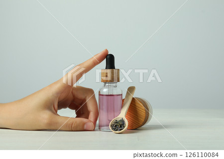 Lavender oil in a bottle on a light background 126110084