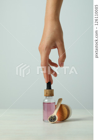 Lavender oil in a bottle on a light background 126110085